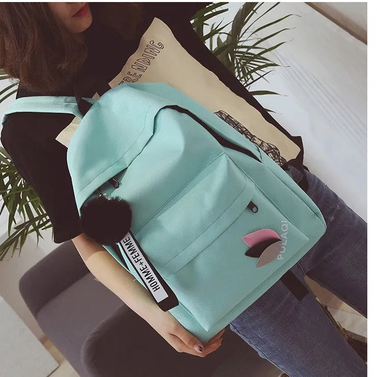 Canvas college style schoolbag backpack in green with leaf pattern, showing 40x28x13cm dimensions