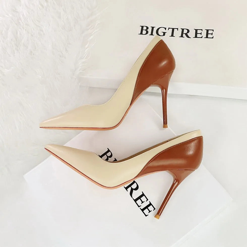 Retro black and creamy-white women's stiletto heels with pointed toe and high thin heel for banquet events.