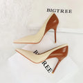 Retro black and creamy-white women's stiletto heels with pointed toe and high thin heel for banquet events.