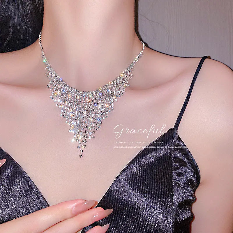 Silver alloy diamond tassel necklace with geometric pendant and ball bead chain on a woman