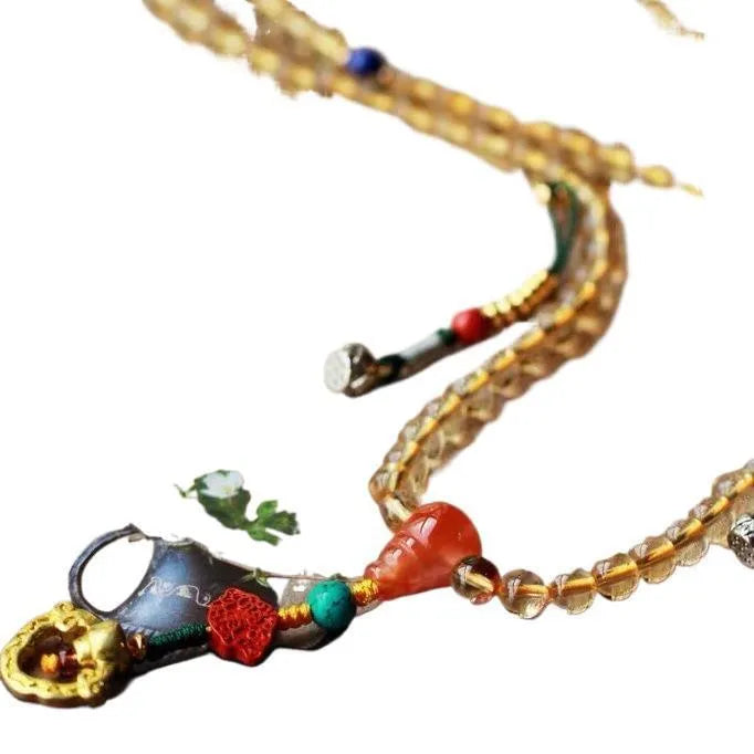 Yellow natural Brazilian citrine bracelet with 1mm beads and filament fastening on a wrist.