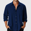 Man wearing a loose-fit long sleeve polyester shirt with a stand collar, available in multiple colours.