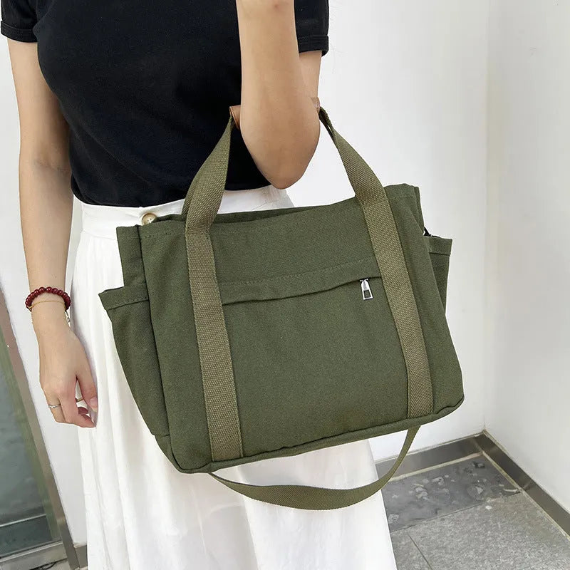 Canvas tote bag with multiple internal pockets including computer pocket, shown in horizontal square shape