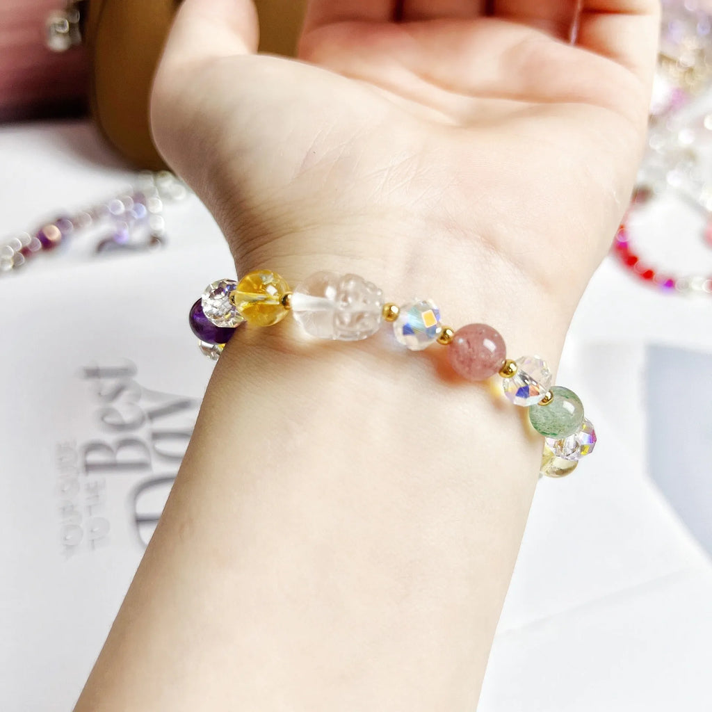 Close-up of a women's crystal bracelet with a detailed nine-tailed fox charm and colour faceted stones.