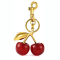 Red cherry-shaped zinc alloy keychain pendant with three-dimensional design on white background