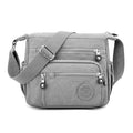 Nylon messenger shoulder bag in square vertical shape shown in light blue colour.