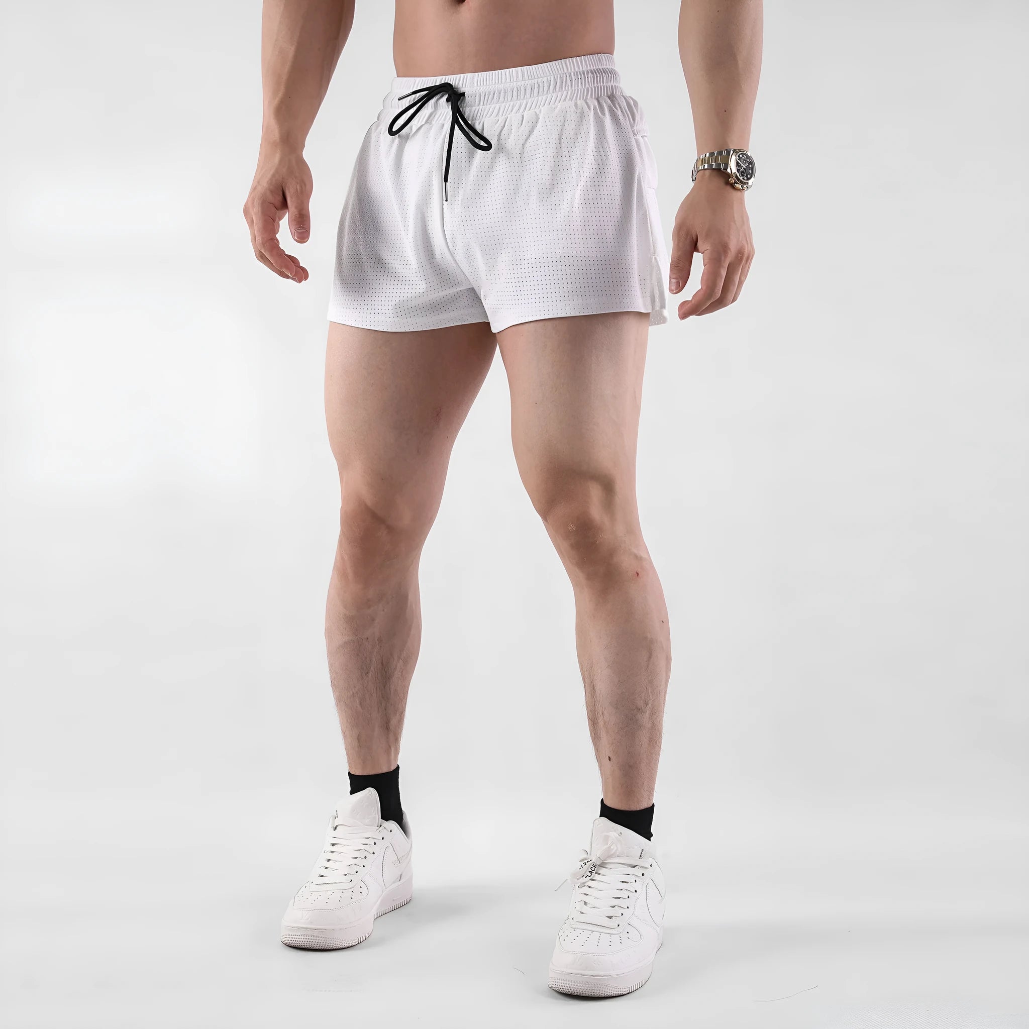 Men's quick-drying nylon shorts in black on a white background, showing mid-waist and short length.