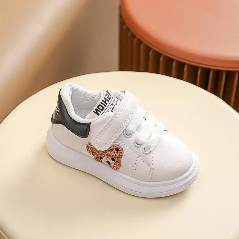 Baby Bear cartoon pattern children's sneakers in green, shown on a white background.