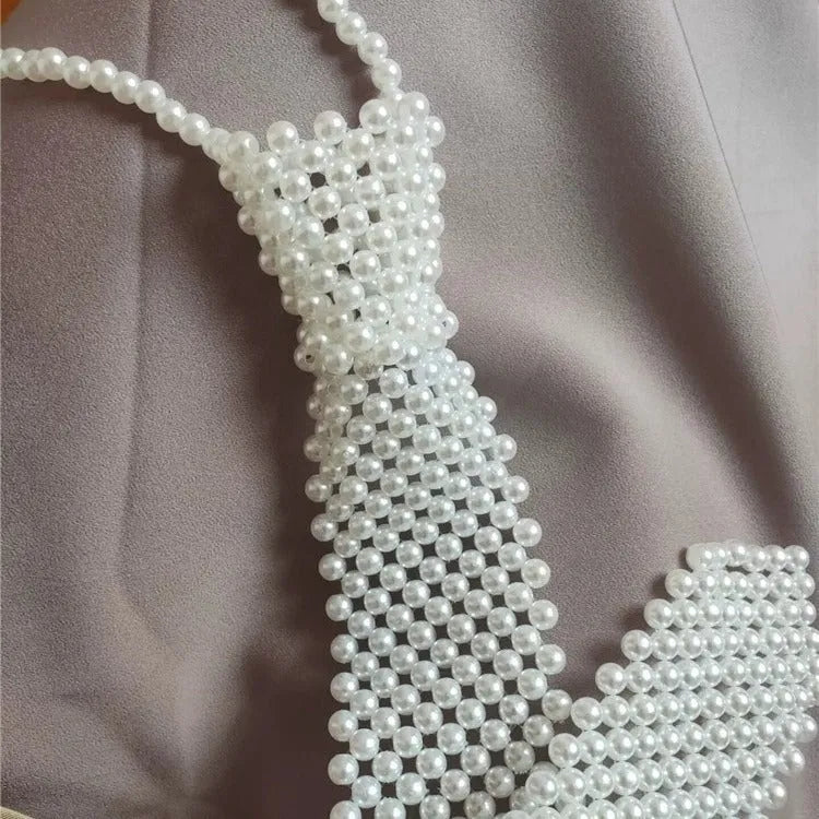 Women's pearl tie body chain with hollow-out design in white or black colour.
