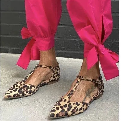 Leopard print women's pumps with pointed toe, cross straps, and low chunky heel