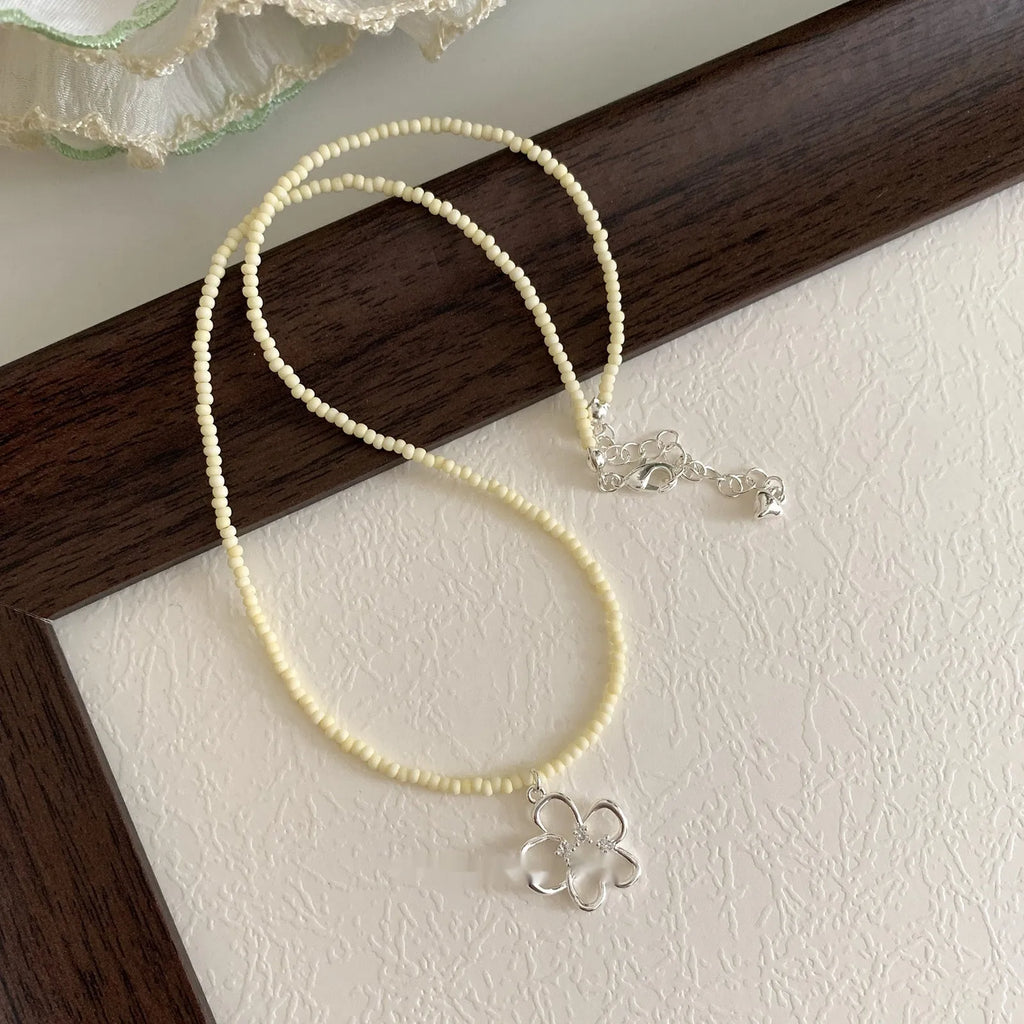 Women's electroplated copper hollow flower necklace with U-shaped pendant and English letters detail
