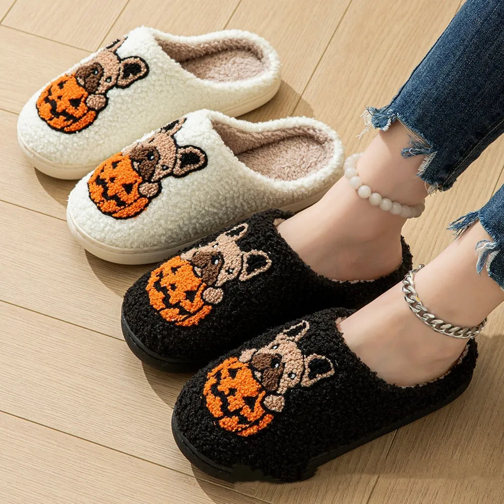 Black Halloween slippers with pumpkin design featuring soft plush upper and non-slip rubber soles.