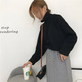 Women's loose-fitting long-sleeve top with a half-high collar in a solid colour.