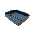 Black rectangular wireless charging storage box for Qi-compatible phones on a desk.