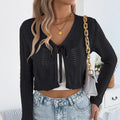 Women's khaki lace-up front coat with hollow-out pattern, worn open as a cardigan.