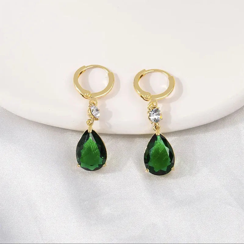 Green geometric teardrop alloy earrings on a white background