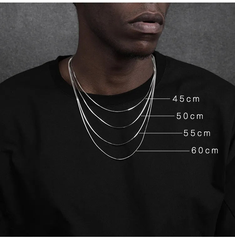 S925 sterling silver plated platinum necklace with fine snake bone chain in silver on neutral background