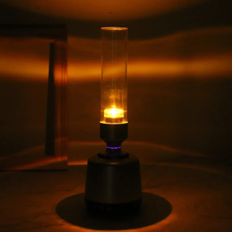 White silver Bluetooth speaker with integrated candlelight atmosphere night light.