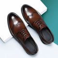 Men's black brogue leather shoes with wingtip perforations and lace-up closure on neutral background