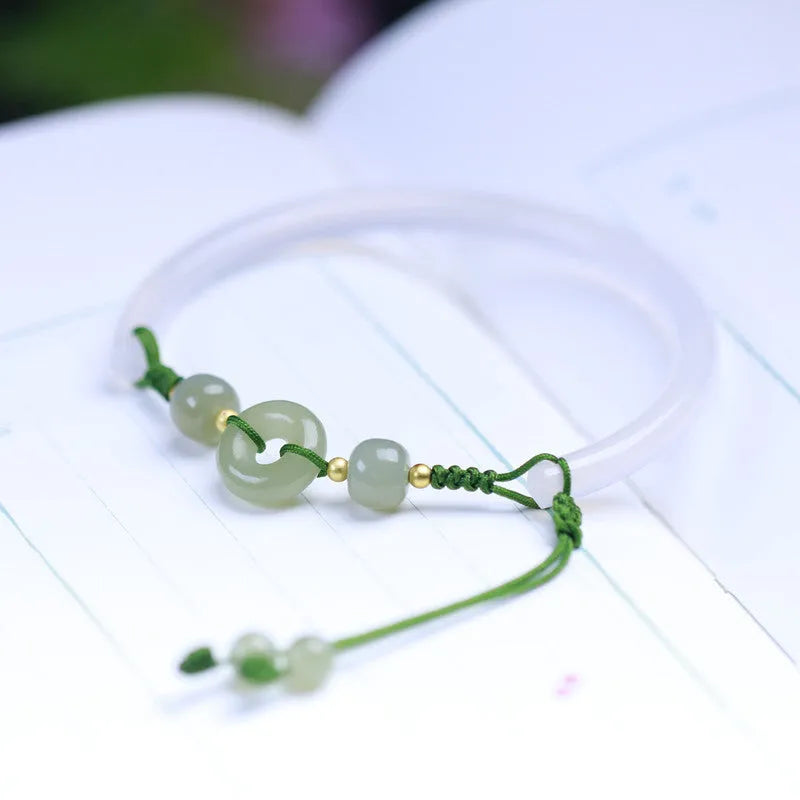 Hand-woven white agate bracelet with hetian jade accents and traditional peace buckle on wrist