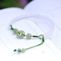 Hand-woven white agate bracelet with hetian jade accents and traditional peace buckle on wrist