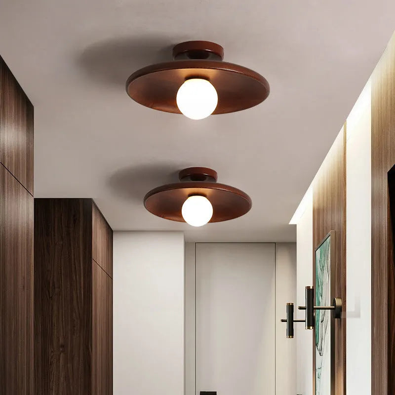 Modern minimalist ceiling lamp with solid wood body and glass shade in wood or walnut colour.