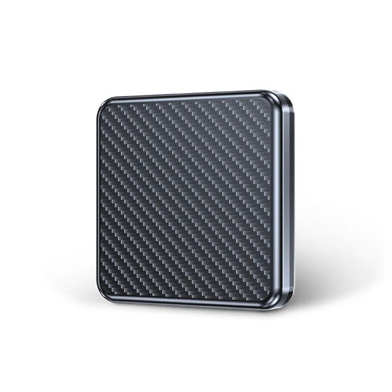 Gold and white wireless CarPlay and Android Auto USB adapter box for cars on a dark surface.