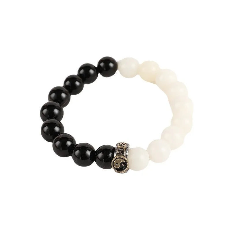Black and white obsidian tai chi bracelet with 10mm geometric beads and bodhi mantra design
