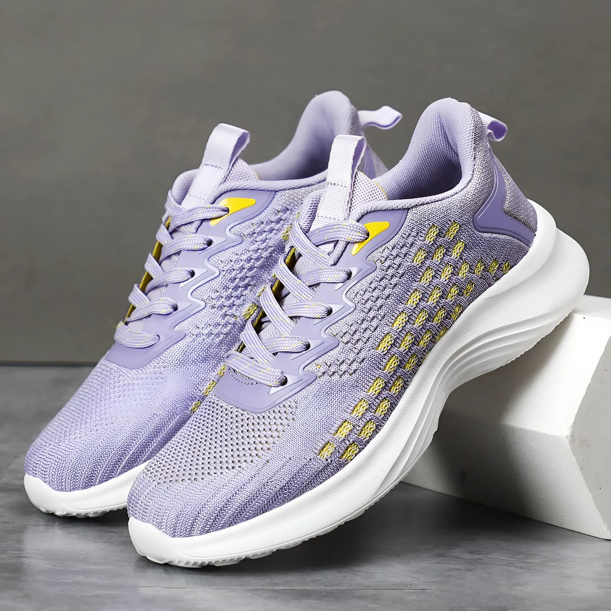 Women's lavender purple flyknit running shoes with mesh upper and striped pattern on a white background.