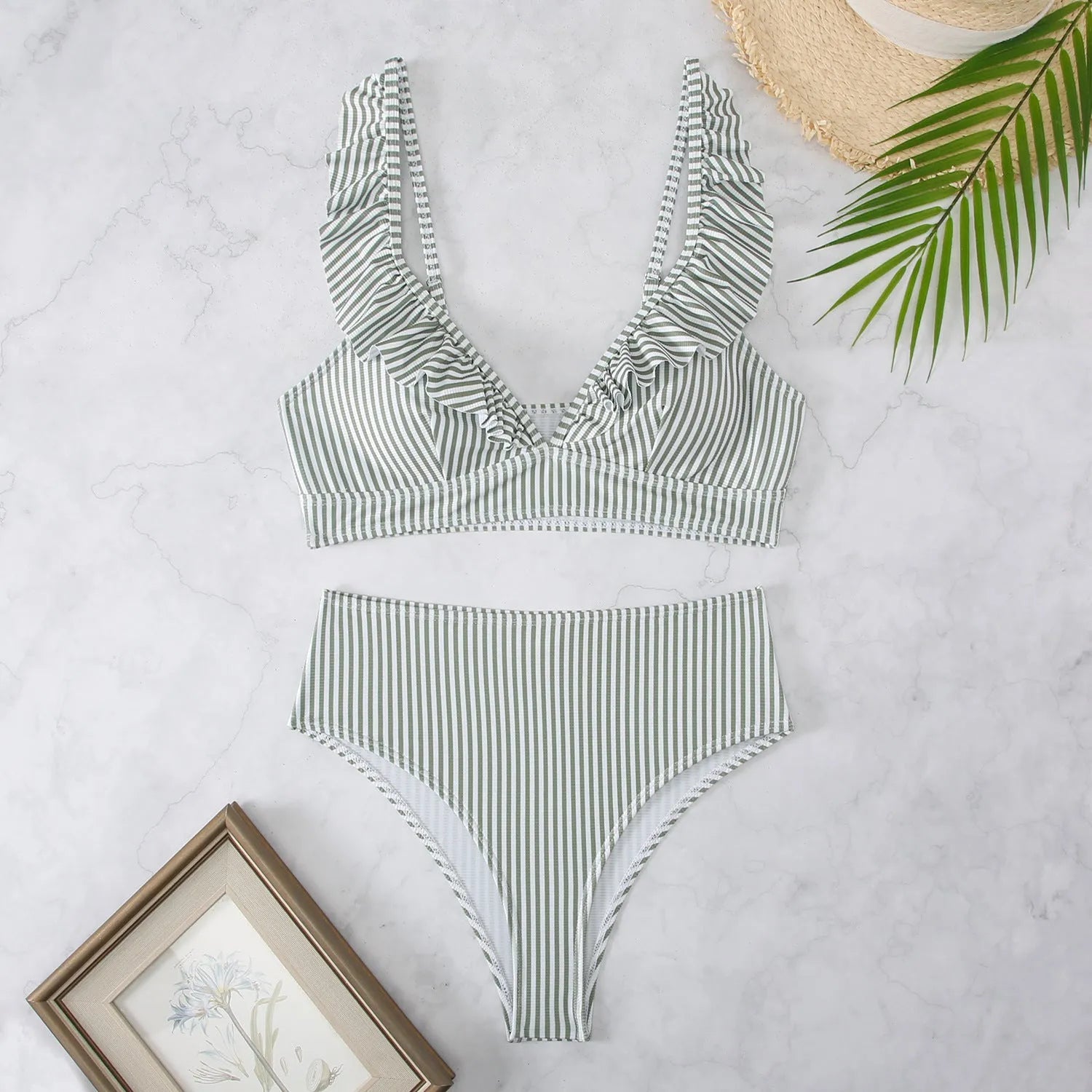Women's black and white striped bikini with split chest design on a mannequin.