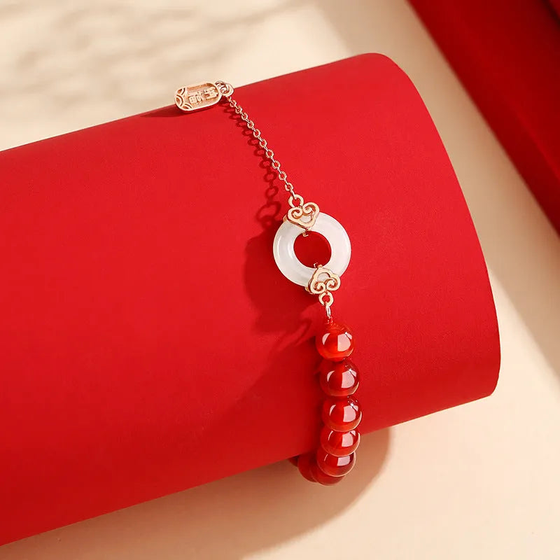 Close-up of a women's sterling silver bracelet with a peace buckle, xiangyun cloud patterns, and a Fu character.