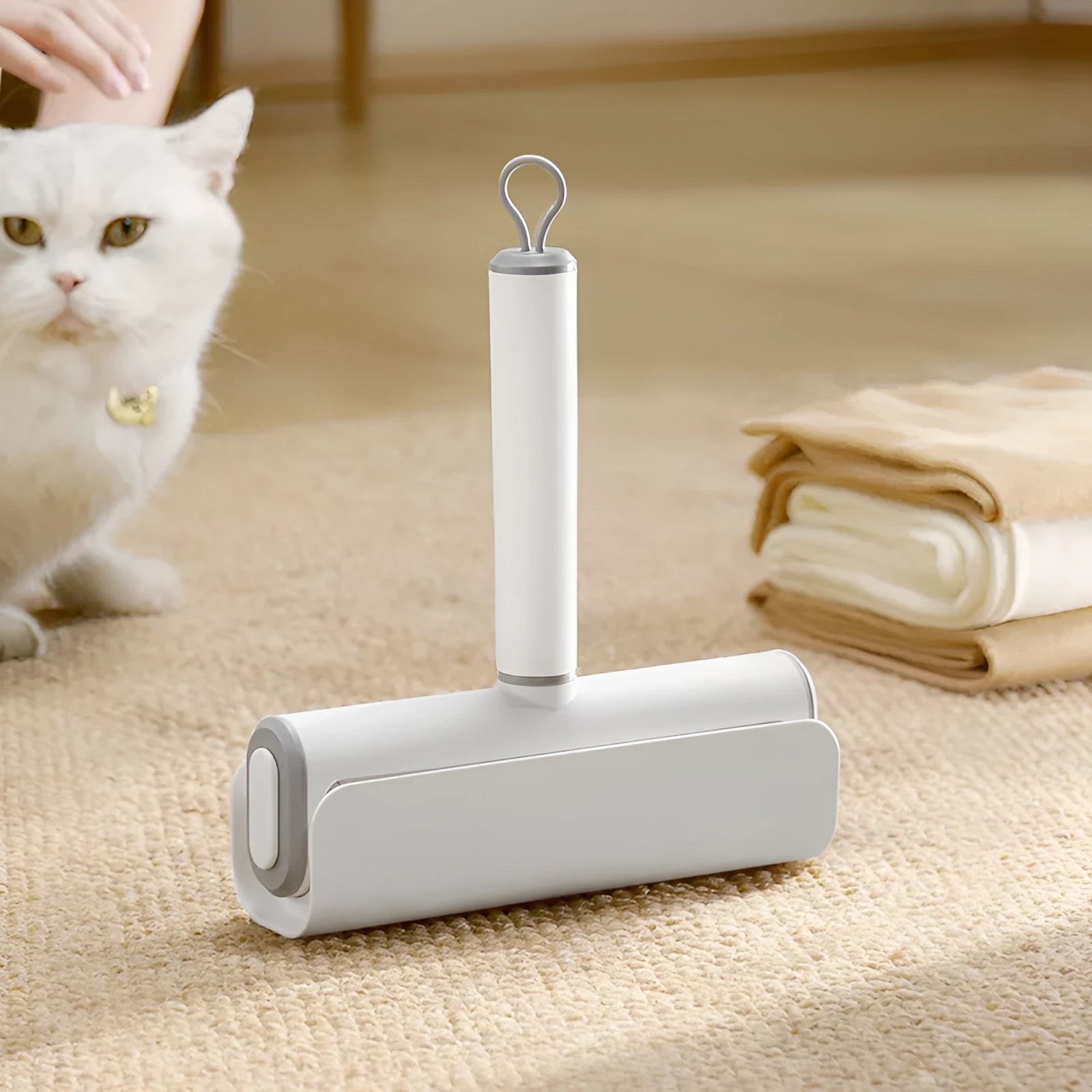 Long-handle lint roller with removable adhesive head for picking up pet hair from floors and furniture