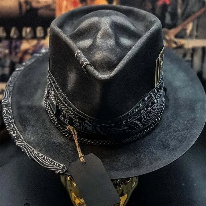 Handmade wool felt skull hat with a pointed conical crown on a neutral background.