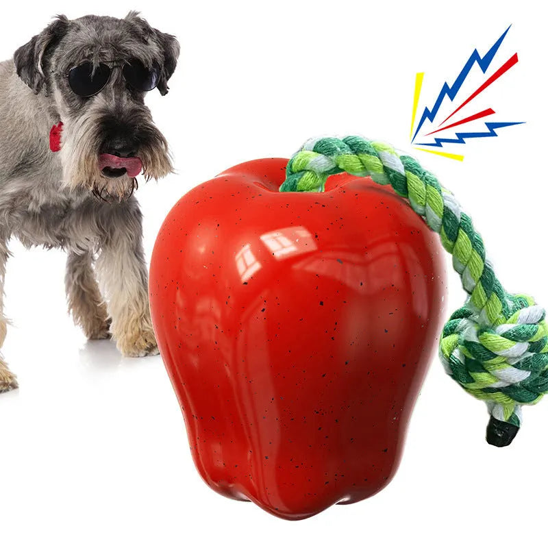 Green and red plastic Apple-shaped dog toy with a slot for dog food and a squeaker inside.
