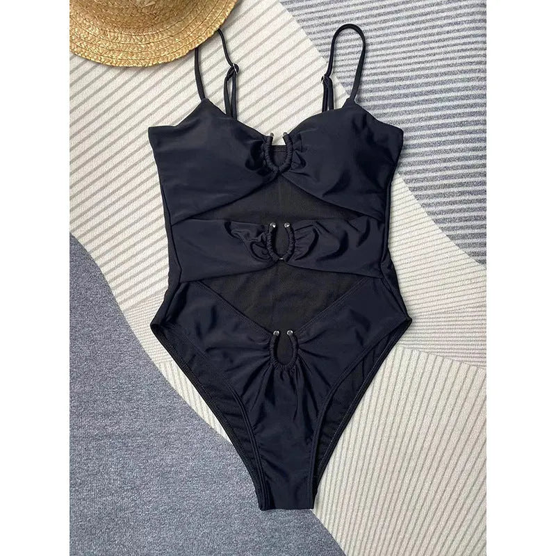 Women's black solid colour one-piece swimsuit with figure-hugging design on mannequin