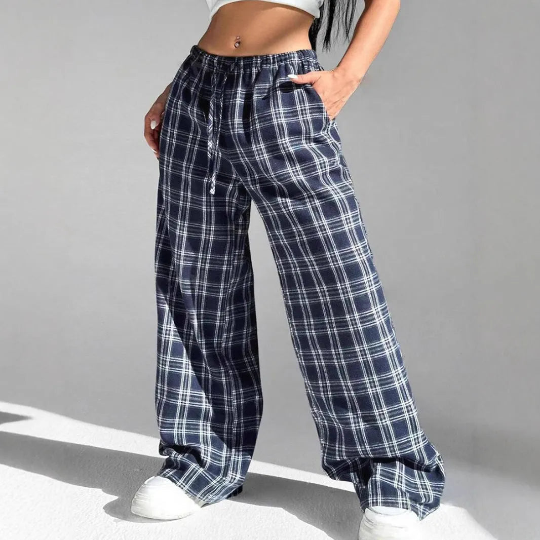 Women's blue plaid trousers with elastic drawstring waist and patch pockets laid flat
