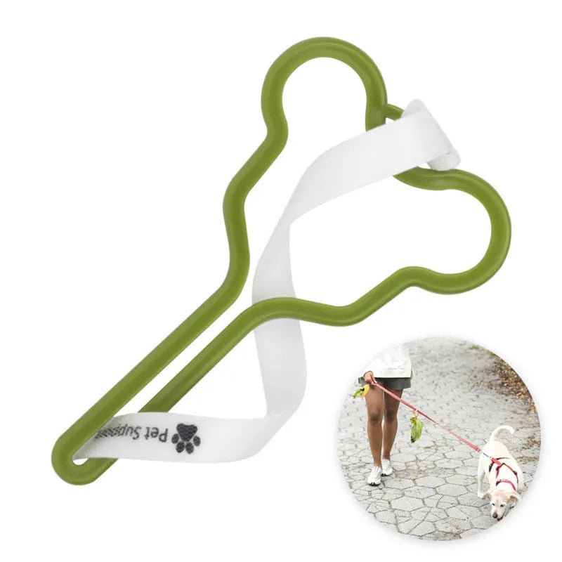 A hands-free dog poop bag holder with a fixed metal clip and a black Velcro strap for leash attachment.
