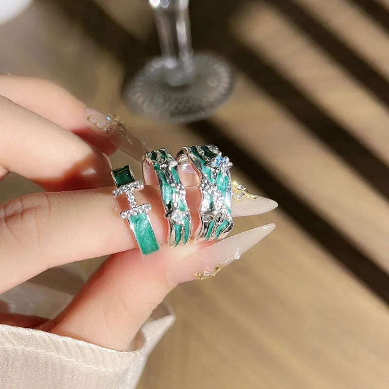 Mint green enamel ring with asymmetrical folded eight-point star design on copper band