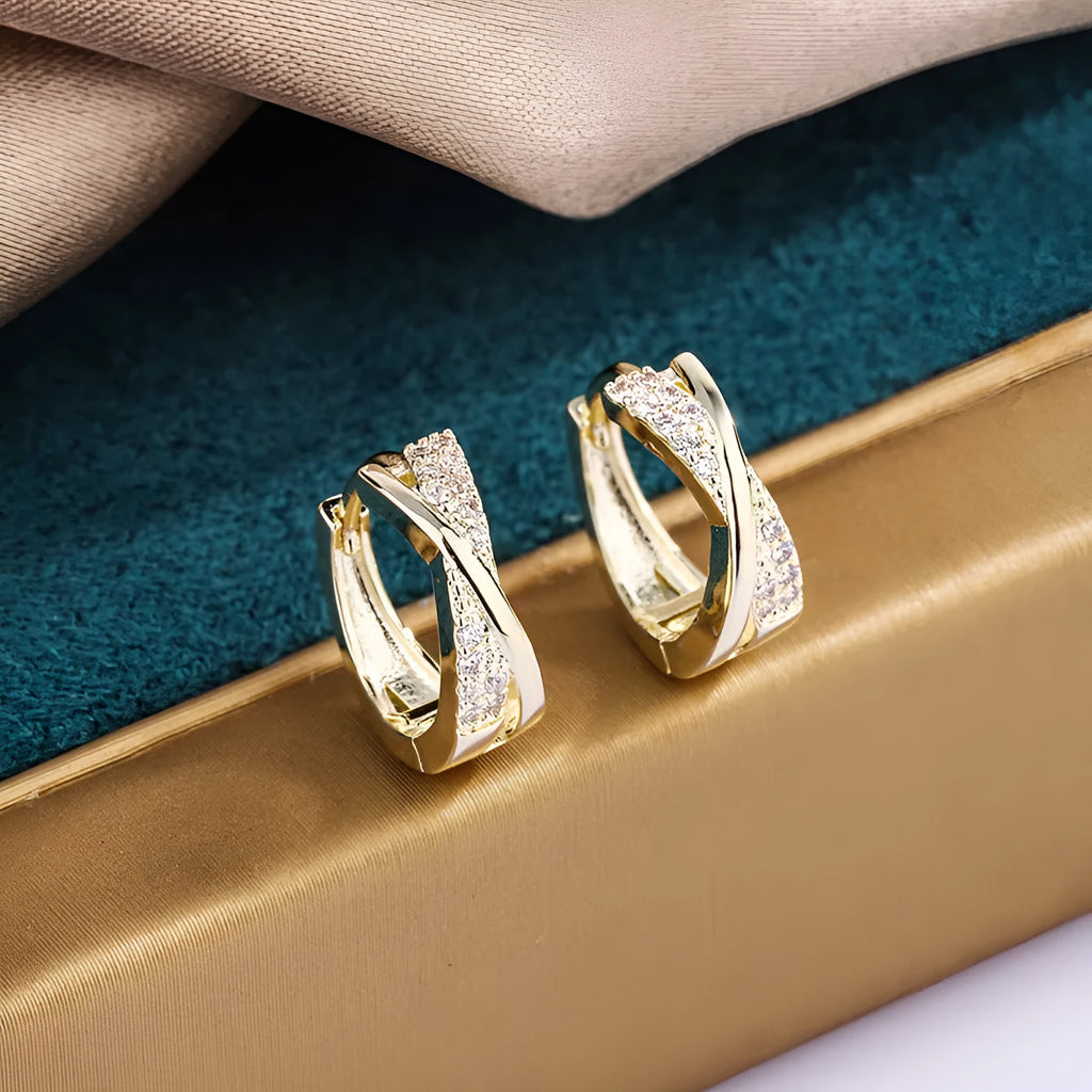 Geometric shaped women's earrings with 14K yellow gold plating and zircon stone details on a copper base.