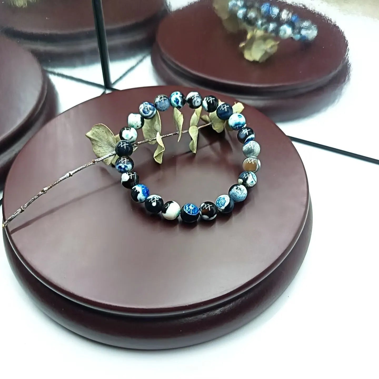 Close-up of a bohemian-style bracelet with 8mm natural agate beads and glass accents on a wrist.