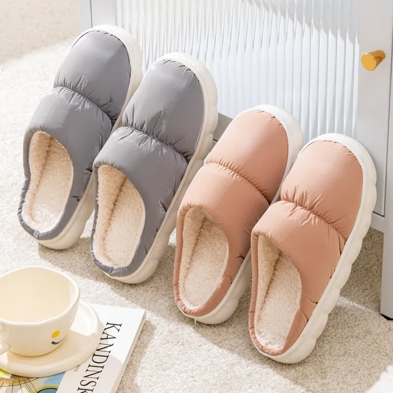 A pair of thick-soled down cotton slippers for men and women in a choice of colours, featuring a non-slip rubber sole.