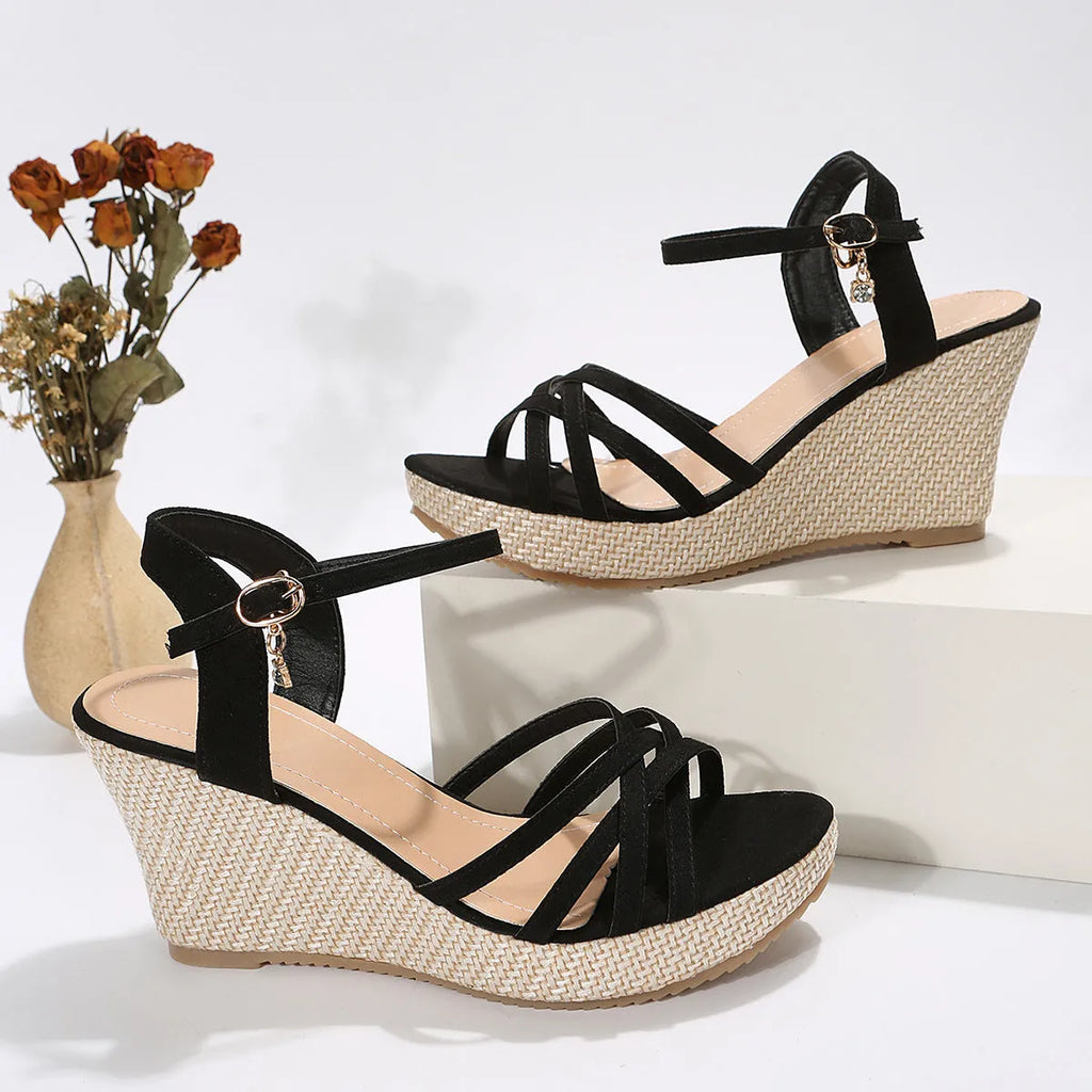 Women's black wedge sandals with cloth upper and fish-mouth toe design on a simple background.