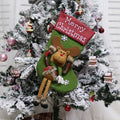 Three large Christmas stockings with 3D Santa, snowman, and reindeer designs hung on tree