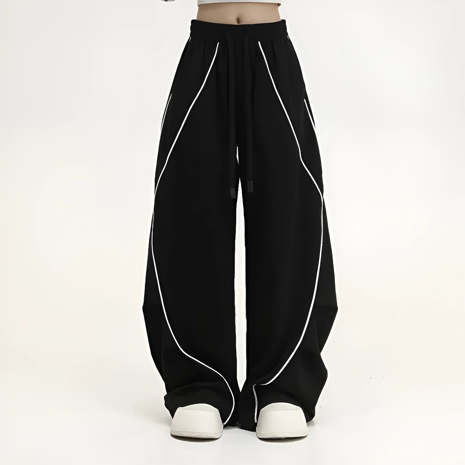 Black striped pleated wide-leg hip hop trousers laid flat, showing loose fit and mid waist.
