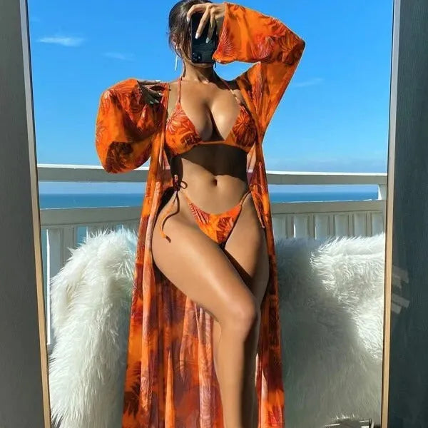 Blue long sleeve bikini set with banded briefs and a matching outer robe laid flat