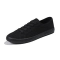 All black women's canvas lace-up work shoes with flat rubber soles.