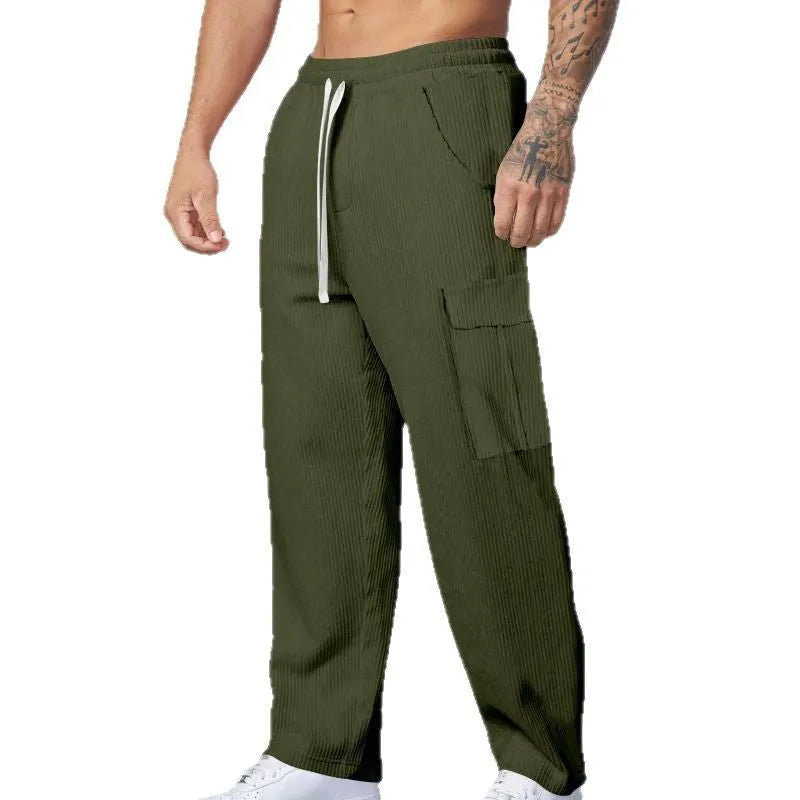 Men's navy blue corduroy wide-leg cargo trousers with a drawstring waist on a neutral background.