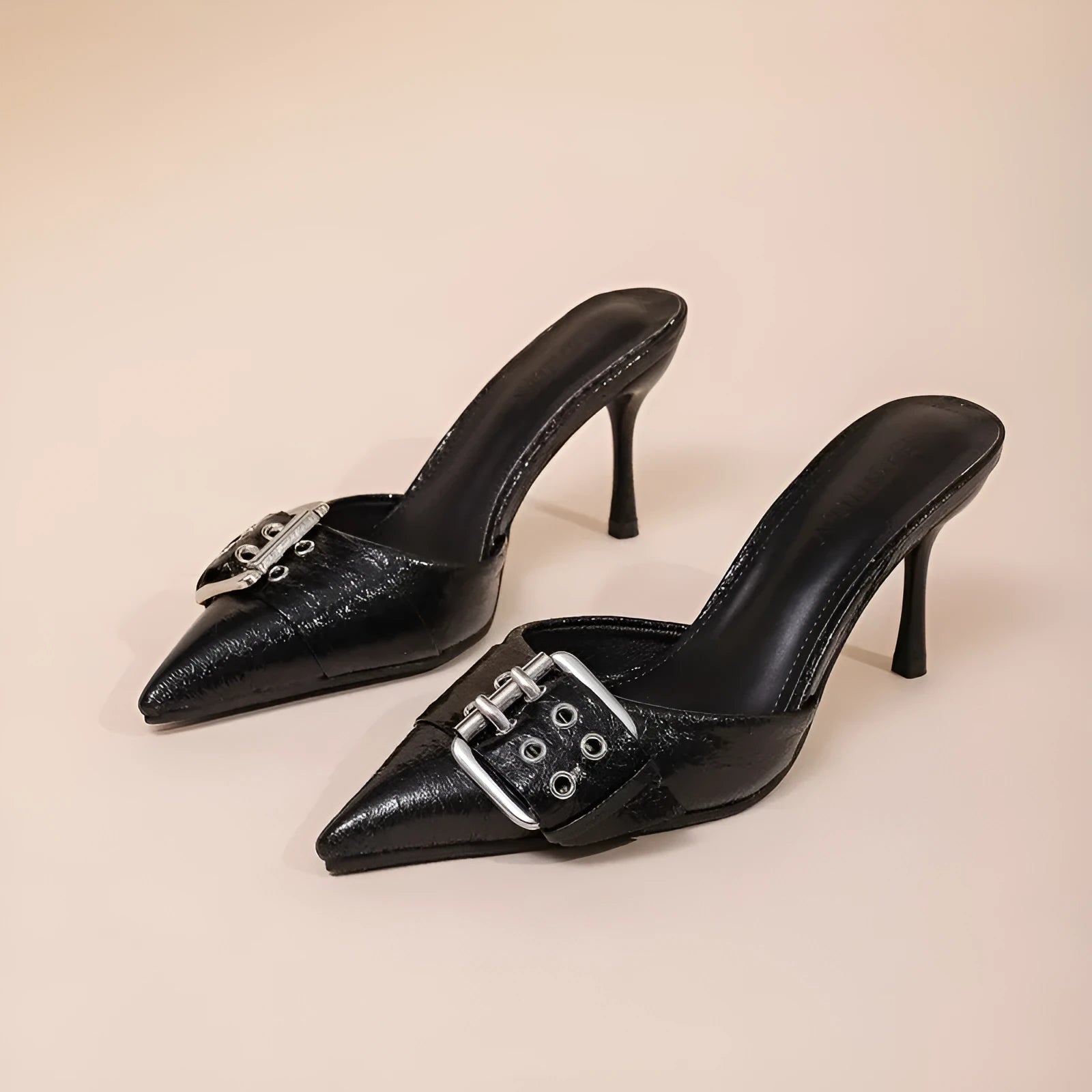 Black women's high heels with decorative buckle on ankle strap and pointed toe design