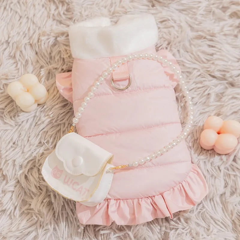 Small dog wearing a pink gingham princess skirt with built-in D-ring for leash attachment