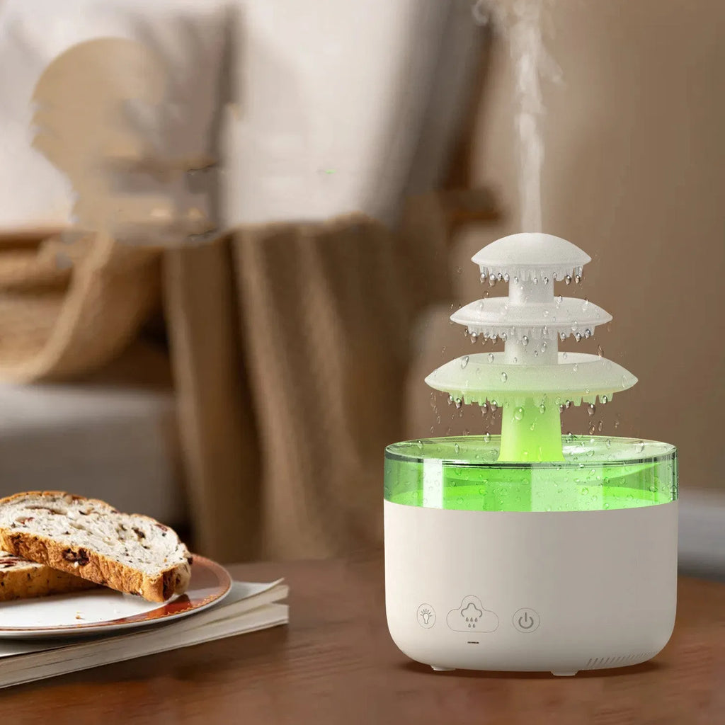 White cloud rain shape ultrasonic humidifier and essential oil diffuser with colourful LED lights on a table.